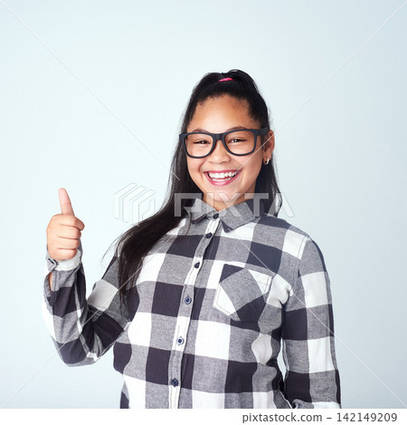 Girl, portrait and child in studio with thumbs up for opinion, agreement and yes in mockup space. Happy, student and thank you emoji for support on project in school with feedback, review and vote Girl, portrait and child in studio with thumbs up for opinion, agreement and yes in mockup space. Happy, student and thank you emoji for support on project in school with feedback, review and vote 142149209
