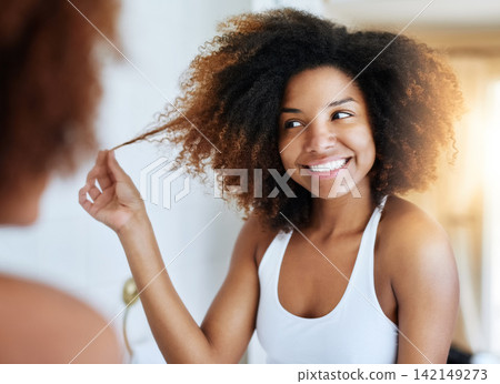 Black woman, afro and mirror hair care in bathroom or curly treatment for healthy hygiene, washing or routine. Female person, reflection and home apartment for morning wellness, texture or growth Black woman, afro and mirror hair care in bathroom or curly treatment for healthy hygiene, washing or routine. Female person, reflection and home apartment for morning wellness, texture or growth 142149273