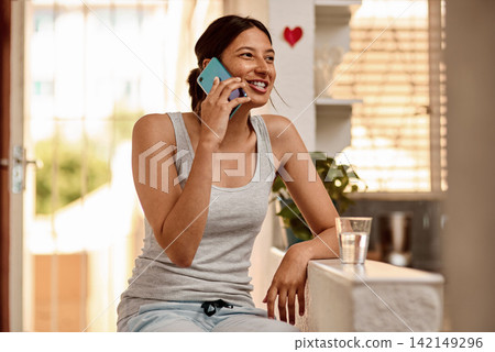 Girl, phone call and talking in home, relax and conversation on weekend morning. Happy female person, gossip and communication for humor in story or news, apartment and speaking to gen z contact Girl, phone call and talking in home, relax and conversation on weekend morning. Happy female person, gossip and communication for humor in story or news, apartment and speaking to gen z contact 142149296