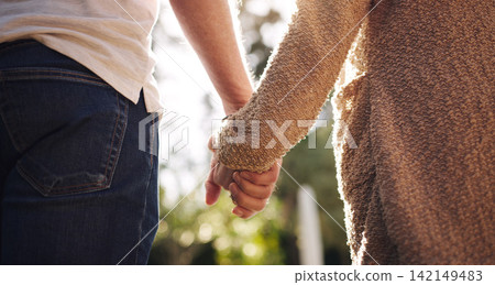 Couple, love and holding hands with back view for relationship, summer and happy date in park. Man, woman and romantic walk together in forest with trust or care for commitment, nature and freedom Couple, love and holding hands with back view for relationship, summer and happy date in park. Man, woman and romantic walk together in forest with trust or care for commitment, nature and freedom 142149483