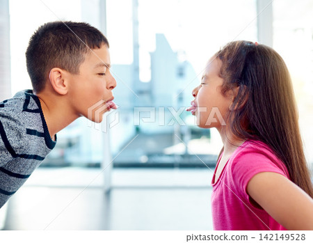 Children, fight or silly with tongue out, problem or frustrated with youth at home in living room. Young, argument or conflict in house, apartment or bedroom with kids for child development or growth Children, fight or silly with tongue out, problem or frustrated with youth at home in living room. Young, argument or conflict in house, apartment or bedroom with kids for child development or growth 142149528
