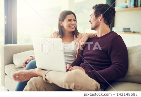Laptop, laughing and couple in living room for movie, show or film entertainment together at home. Happy, love and people relaxing on sofa and streaming funny, comic or comedy video on computer. Laptop, laughing and couple in living room for movie, show or film entertainment together at home. Happy, love and people relaxing on sofa and streaming funny, comic or comedy video on computer. 142149685