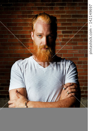 Man, portrait and confident outfit by brick wall, pride and rings or jewelry for tattoo style. Male person, serious face and gen z or arms crossed for aesthetic, designer clothes and weekend travel Man, portrait and confident outfit by brick wall, pride and rings or jewelry for tattoo style. Male person, serious face and gen z or arms crossed for aesthetic, designer clothes and weekend travel 142149697