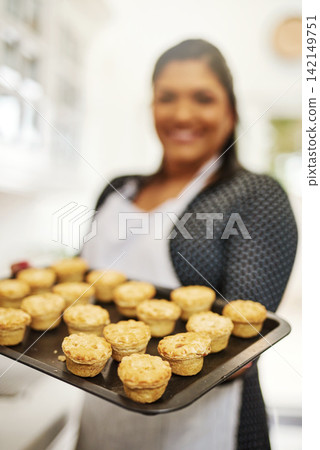Pastry, chef and cooking in bakery with tray of pies, order and process in kitchen or restaurant. Dessert, production and woman in hospitality, catering or service in cafeteria with food for dinner Pastry, chef and cooking in bakery with tray of pies, order and process in kitchen or restaurant. Dessert, production and woman in hospitality, catering or service in cafeteria with food for dinner 142149751