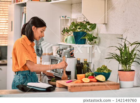 Cooking, food and recipe with woman in kitchen of home for preparation of diet, health or nutrition. Ingredients, stove and vegetables with person making dinner in apartment for hunger or meal Cooking, food and recipe with woman in kitchen of home for preparation of diet, health or nutrition. Ingredients, stove and vegetables with person making dinner in apartment for hunger or meal 142149760