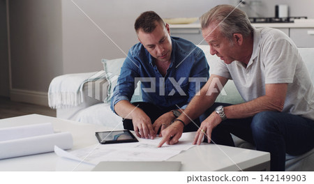 Men, real estate and family with blueprint in home, tablet and together for planning of investment. Reading, document and paper of property, father and son in business for house in lounge and couch Men, real estate and family with blueprint in home, tablet and together for planning of investment. Reading, document and paper of property, father and son in business for house in lounge and couch 142149903