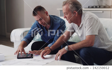 Father, son and planning with blueprint in home, tablet and together for investment in real estate. Reading, document and paper for property, men and family in business for house, lounge and couch Father, son and planning with blueprint in home, tablet and together for investment in real estate. Reading, document and paper for property, men and family in business for house, lounge and couch 142150012