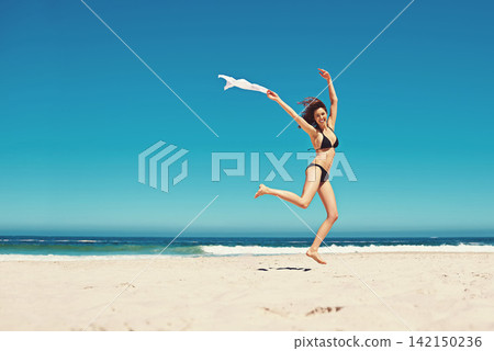 Woman, portrait and bikini or ocean jump for holiday freedom on tropical island, beach or adventure. Female person, swimwear and smile in Bali for paradise weekend with summer trip, coast or sand Woman, portrait and bikini or ocean jump for holiday freedom on tropical island, beach or adventure. Female person, swimwear and smile in Bali for paradise weekend with summer trip, coast or sand 142150236