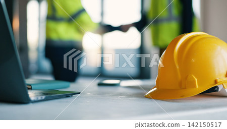 Architect, helmet and handshake in office for safety inspection, agreement and project collaboration. People, shaking hands and hard hat in meeting for construction rule compliance, teamwork or deal. 142150517