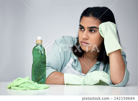 Frustrated, woman and thinking about cleaning with gloves, detergent and cloth for house chores in studio. Depressed, female person and spray bottle with chemicals from anxiety for bacteria and germs Frustrated, woman and thinking about cleaning with gloves, detergent and cloth for house chores in studio. Depressed, female person and spray bottle with chemicals from anxiety for bacteria and germs 142150684