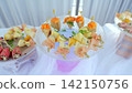 Elegantly prepared catering table displaying gourmet appetizers and diverse snacks for corporate, festive, or wedding celebration event 142150756