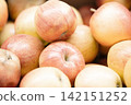 Fresh ripe apples close-up. Fresh ripe apples with a beautiful red-yellow blush. Fruit and vegetable stand. Autumn harvest. 142151252