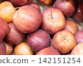 Fresh ripe apples close-up. Fresh ripe apples with a beautiful red-yellow blush. Fruit and vegetable stand. Autumn harvest. 142151254