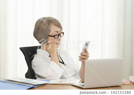 Senior women working in an office 142151380