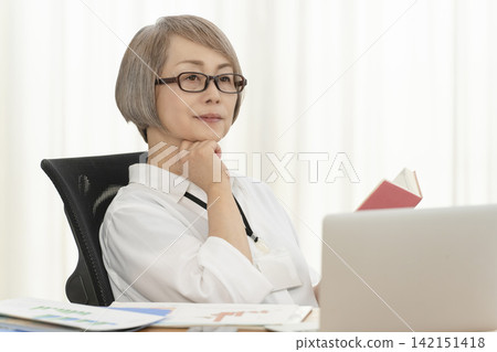 Senior women working in an office Senior women working in an office 142151418