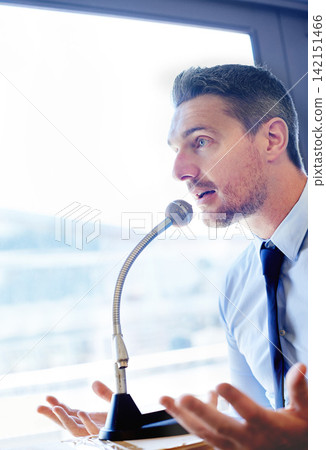 Businessman, speech and presentation with mic for talk or discussion on podium at office. Man, politician or business spokesperson in conversation or political debate with speaker or desk microphone Businessman, speech and presentation with mic for talk or discussion on podium at office. Man, politician or business spokesperson in conversation or political debate with speaker or desk microphone 142151466
