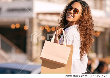 Woman, sunglasses and shopping bag in city or gift discount or retail sale, product or promotion. Female person, travel and happy in California with buying purchase or fashion deal, urban or customer 142151475