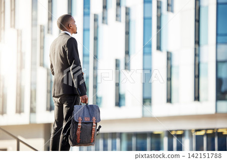 Back view, businessman and thinking by building in city for sight seeing, journey and travel to work. Black male person, airport and immigration for new career, promotion and startup company project Back view, businessman and thinking by building in city for sight seeing, journey and travel to work. Black male person, airport and immigration for new career, promotion and startup company project 142151788