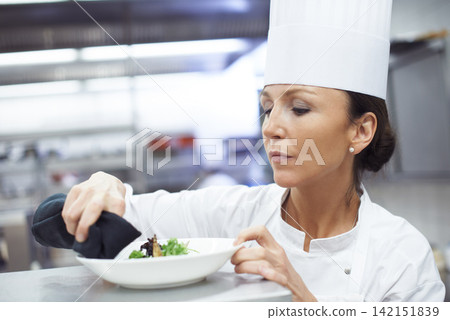 Professional, chef and woman or plating food, restaurant and executive cook and gourmet meal prep. Serious, catering and culinary presentation for fine dining, nutrition and hospitality industry Professional, chef and woman or plating food, restaurant and executive cook and gourmet meal prep. Serious, catering and culinary presentation for fine dining, nutrition and hospitality industry 142151839