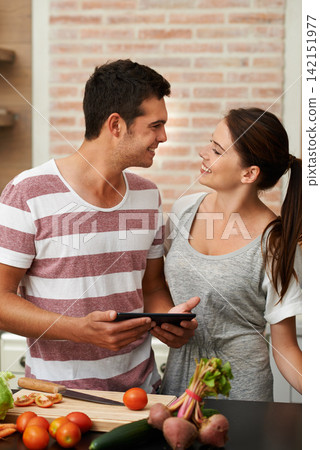 Cooking, tablet and couple in kitchen for healthy food or vegetables for lunch or dinner recipe. Online, tutorial and romantic woman in meal prep for salad preparation or hungry vegan man in home Cooking, tablet and couple in kitchen for healthy food or vegetables for lunch or dinner recipe. Online, tutorial and romantic woman in meal prep for salad preparation or hungry vegan man in home 142151977