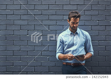 Business man, tablet and research online, reading email or info on a wall background in city. Serious, digital tech and professional on website, app or financial consultant networking on internet Business man, tablet and research online, reading email or info on a wall background in city. Serious, digital tech and professional on website, app or financial consultant networking on internet 142152043