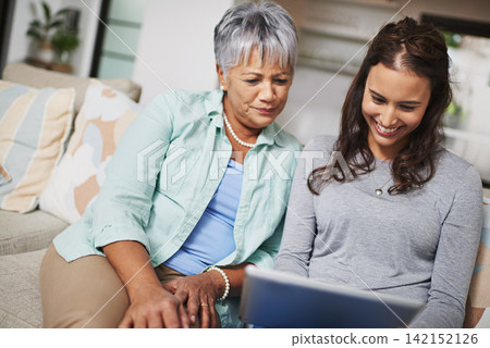 Happy, tablet and woman teaching senior mother networking on internet, mobile app or website on sofa. Smile, bonding and elderly mom learning digital technology with female person in living room. Happy, tablet and woman teaching senior mother networking on internet, mobile app or website on sofa. Smile, bonding and elderly mom learning digital technology with female person in living room. 142152126