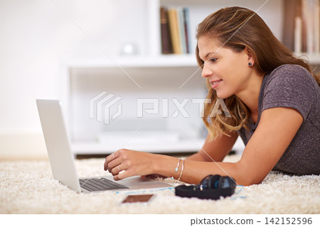 Woman, laptop floor and home for student, education and elearning for online research. Typing, relax and study with computer for project or assignment, female person and swim for calm in house lounge Woman, laptop floor and home for student, education and elearning for online research. Typing, relax and study with computer for project or assignment, female person and swim for calm in house lounge 142152596