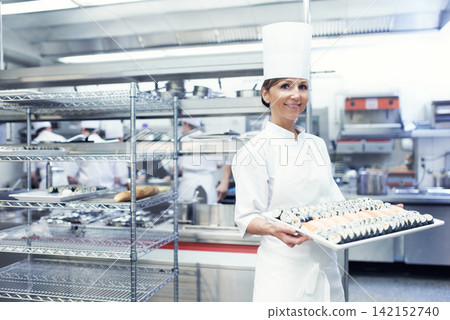 Sushi, female chef and restaurant in portrait with cuisine for catering service or food presentation. Fine dining, cooking and culinary industry for hospitality with accommodation with confidence Sushi, female chef and restaurant in portrait with cuisine for catering service or food presentation. Fine dining, cooking and culinary industry for hospitality with accommodation with confidence 142152740