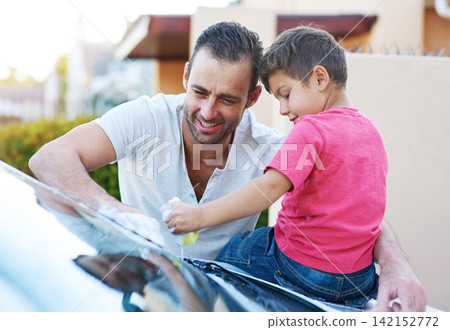 Chores, washing car and father with son in driveway of home in summer together for child development. Family, love or smile with happy parent and boy kid cleaning vehicle outdoor for responsibility 142152772