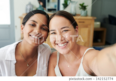 Happy woman, friends and portrait with selfie for memory, bonding or moment together at home. Female person or young people with smile for picture, photography or capture on living room sofa at house Happy woman, friends and portrait with selfie for memory, bonding or moment together at home. Female person or young people with smile for picture, photography or capture on living room sofa at house 142152774