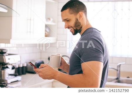 Home, coffee and man with smartphone, typing and connection with internet and latte in kitchen. Person in house, mobile user or guy with morning tea or cappuccino with cellphone, text or social media Home, coffee and man with smartphone, typing and connection with internet and latte in kitchen. Person in house, mobile user or guy with morning tea or cappuccino with cellphone, text or social media 142152790