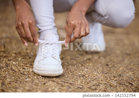 Hands, hiking and tying shoes with person outdoor in nature for fitness, hobby or recreation closeup. Exercise, ground and park with hiker getting ready for sports, training or workout in park Hands, hiking and tying shoes with person outdoor in nature for fitness, hobby or recreation closeup. Exercise, ground and park with hiker getting ready for sports, training or workout in park 142152794