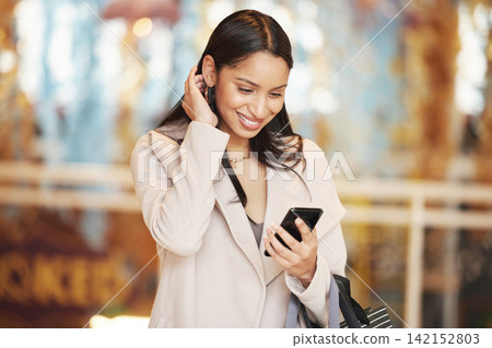 Woman, smartphone and online in mall with bag for bargain notification, social media and internet. Female person, retail shopping and happy with tech for communication, mobile app and website sale Woman, smartphone and online in mall with bag for bargain notification, social media and internet. Female person, retail shopping and happy with tech for communication, mobile app and website sale 142152803