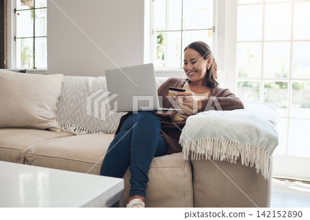Woman, laptop and credit card on couch to pay, finance and website for online shopping in home. Female person, ecommerce and code for transfer or purchase, sofa and app for banking or budget on tech 142152890
