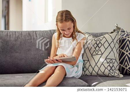 Happy, home and girl on couch, tablet and typing for games, social media and online cartoon. Apartment, child development or kid with tech, internet or digital app with network, smile or reading book Happy, home and girl on couch, tablet and typing for games, social media and online cartoon. Apartment, child development or kid with tech, internet or digital app with network, smile or reading book 142153071
