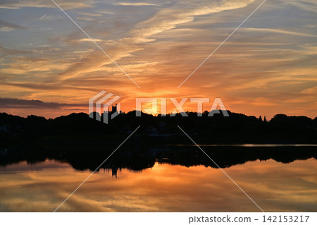 The sunrise reflected on the surface of the river The sunrise reflected on the surface of the river 142153217