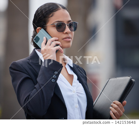 Business, woman and phone call in city on commute in morning with chat to client or networking. Consulting, attorney and virtual conversation on street with smartphone at court to contact with news Business, woman and phone call in city on commute in morning with chat to client or networking. Consulting, attorney and virtual conversation on street with smartphone at court to contact with news 142153648