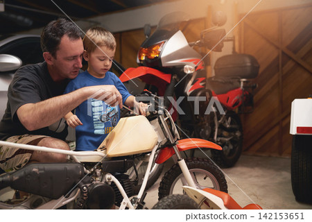 Parent, son and fixing with bike in garage at home for teamwork, support and repair with tools. Family, father and child for bonding, helping and together as mechanic for motorbike in carport Parent, son and fixing with bike in garage at home for teamwork, support and repair with tools. Family, father and child for bonding, helping and together as mechanic for motorbike in carport 142153651