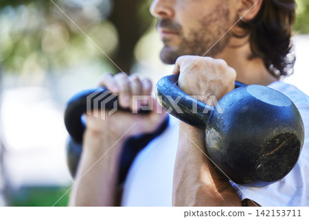 Outdoor, fitness and man with kettlebell in park for exercise, training and workout in nature. Sports, male person and equipment for muscle strength, physical and wellness with weight lifting Outdoor, fitness and man with kettlebell in park for exercise, training and workout in nature. Sports, male person and equipment for muscle strength, physical and wellness with weight lifting 142153711
