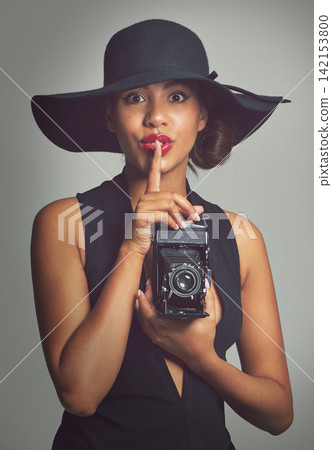 Fashion, portrait and photographer for woman, shush and studio on gray background. Face, confident and gesture for secret with elegant outfit, classy and clothes with glamour accessory in Brazil Fashion, portrait and photographer for woman, shush and studio on gray background. Face, confident and gesture for secret with elegant outfit, classy and clothes with glamour accessory in Brazil 142153800