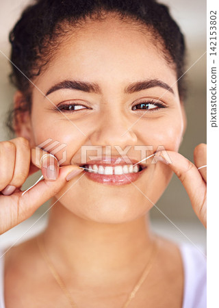 Smile, floss and woman with cleaning teeth routine for morning dental health or wellness for gums. Happy, dentistry and female person with oral care product for hygiene treatment to prevent cavity. Smile, floss and woman with cleaning teeth routine for morning dental health or wellness for gums. Happy, dentistry and female person with oral care product for hygiene treatment to prevent cavity. 142153802