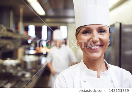 Smile, portrait and woman chef in kitchen for cooking meal, supper or dinner with gourmet cuisine. Confident, happy and face of female culinary worker with catering career in restaurant or diner. Smile, portrait and woman chef in kitchen for cooking meal, supper or dinner with gourmet cuisine. Confident, happy and face of female culinary worker with catering career in restaurant or diner. 142153889