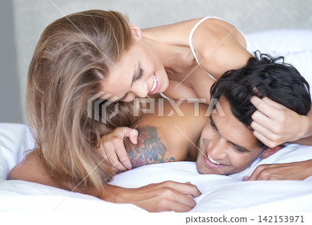 Couple, relax and play in bed in morning, love and romance bonding in home for relationship. Happy people, wake up and security in marriage connection, care and rest in hotel or playful on honeymoon Couple, relax and play in bed in morning, love and romance bonding in home for relationship. Happy people, wake up and security in marriage connection, care and rest in hotel or playful on honeymoon 142153971