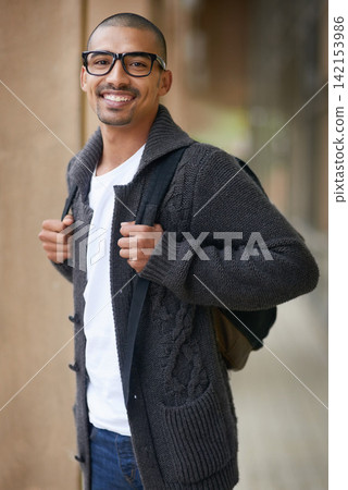 Smiling, student and portrait in hallway with backpack, glasses and casual fashion in college for lecture. Gen z man, happy and ready on campus for lesson, class and learning for education or degree Smiling, student and portrait in hallway with backpack, glasses and casual fashion in college for lecture. Gen z man, happy and ready on campus for lesson, class and learning for education or degree 142153986