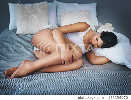 Stomach pain, stress and woman in bed with pms, endometriosis or gut health crisis at home. Uterus, virus and anxiety in bedroom for digestion, emergency or menstruation, gas or constipation disaster Stomach pain, stress and woman in bed with pms, endometriosis or gut health crisis at home. Uterus, virus and anxiety in bedroom for digestion, emergency or menstruation, gas or constipation disaster 142154070