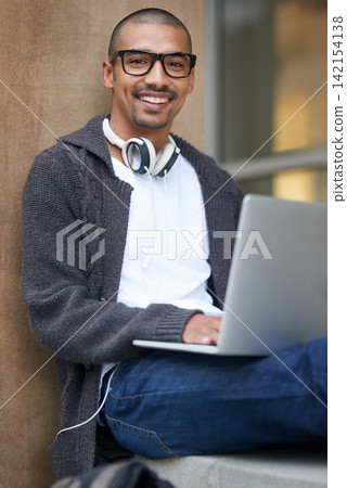 Portrait, man and student with laptop, smile and research for project, elearning and internet. Face, college and person on campus, computer and writer with connection or email for bursary application 142154138
