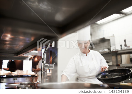 Cooking, chef and happy woman in kitchen at restaurant for fine dining, service and hospitality. Expert, culinary professional and worker with pan for meal prep, dinner or frying food for catering Cooking, chef and happy woman in kitchen at restaurant for fine dining, service and hospitality. Expert, culinary professional and worker with pan for meal prep, dinner or frying food for catering 142154189