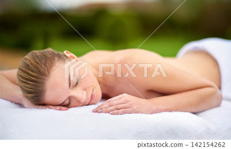 Spa, relax and massage with woman on bed for healing, treatment or pamper in peace at luxury hotel. Female person, client and sleeping with body care at resort for wellness, peace or rest on vacation Spa, relax and massage with woman on bed for healing, treatment or pamper in peace at luxury hotel. Female person, client and sleeping with body care at resort for wellness, peace or rest on vacation 142154262