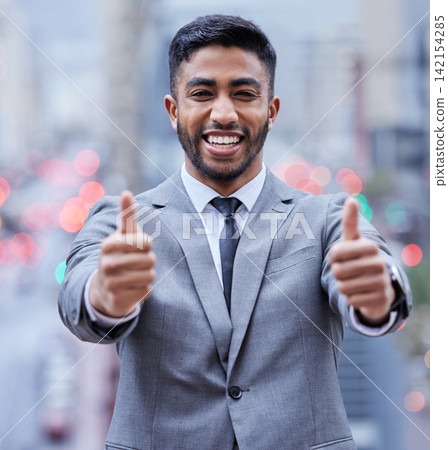 Yes, portrait and businessman with thumbs up in a city for motivation, support or thank you gesture. Face, happy and Indian entrepreneur outdoor with winner, hands or travel agency service review Yes, portrait and businessman with thumbs up in a city for motivation, support or thank you gesture. Face, happy and Indian entrepreneur outdoor with winner, hands or travel agency service review 142154285
