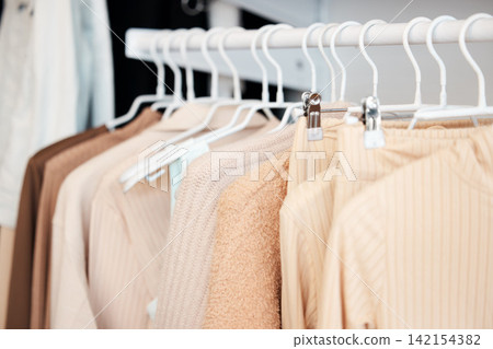Retail, hanger and clothing in store, fashion and boutique for sale for designer garments. Rack, fabric and casual wardrobe outfit choice, rail and purchase or shop for pastel discount material Retail, hanger and clothing in store, fashion and boutique for sale for designer garments. Rack, fabric and casual wardrobe outfit choice, rail and purchase or shop for pastel discount material 142154382